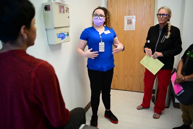 Medical assistant Helda McCauley, center, translates for certified physician assistant Sue Covington, right, to communicate with a patient at the Doctors Care clinic in Littleton on Thursday, May 30, 2024. (Photo by Hyoung Chang/The Denver Post)